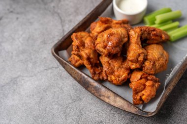 Buffalo chicken wings with celery and dip