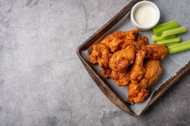 Buffalo chicken wings with celery and dip