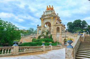 An ornate and beautifully designed structure lies surrounded by lush greenery and elegant pathways inviting exploration