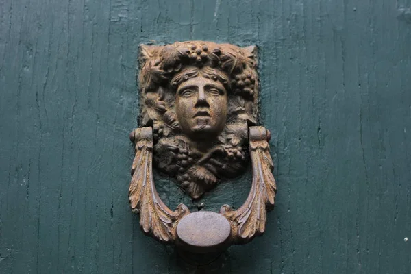 old wooden door with a women head