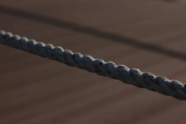 rope on an old wooden deck with ropes on the background