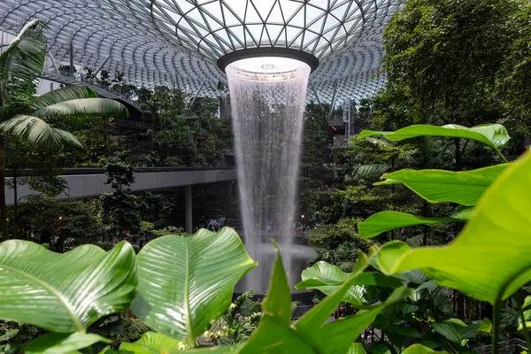 The world\'s tallest indoor waterfall and iconic indoor waterfall at Jewel Changi Airport at Singapore offer an immersive rain vortex experience