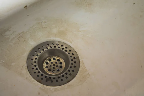dirty, clogged sink in stains and divorces. dirty water faucet with stains and leaks