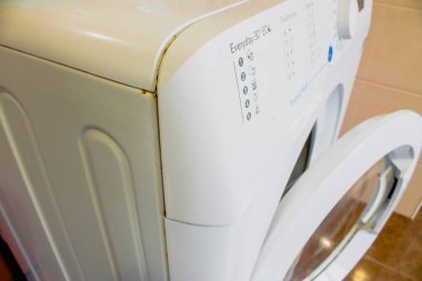 the washing machine in the bathroom is rusting