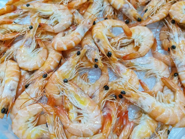 Stock image Detailed view of several whole fresh prawns surrounded by crushed ice for sale at a supermarket fishmonger, commercial food photography...