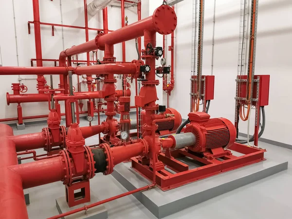 stock image View at industrial electrically powered water pumps and pipes, this pumping group serves for water injection for building fires, sprinklers and fire reels View industrial electrically powered pump...