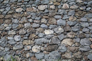 Architecture textures, detailed view of a traditional paired masonry, mixed granite and limestone wall, used on a fortress castle wall...