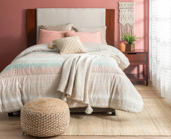 interior of bedroom with double bed, pillows and Woven Pouf, Bedding Set pastel colors, Cotton Blanket