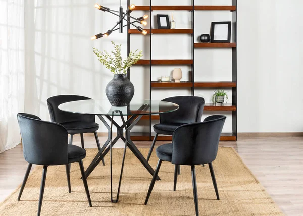interior shot of a modern style dining room area, featuring a wooden table with four chairs, a bookshelf, and two ladders