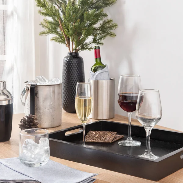 A Set of Fine Wine Glasses and a Wine Bottle on a Tray in a Modern Kitchen with a Festive Christmas Celebration Atmosphere