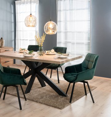 Modern dining room with tableware on a wooden table and a set of green chairs in Scandinavian style, against a gray neutral background clipart