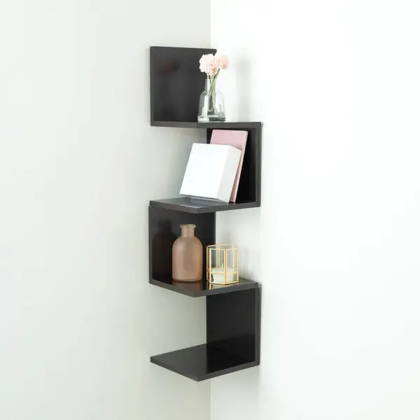 Modern, Minimalist Black Wooden Corner Bookshelf with Books, Ornaments, and Home Decor on a Well-Illuminated White Wall, Natural Light.
