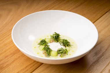 Lezzetli balık ve ıspanak kreması, beyaz tabakta servis ediliyor. Güzel ve gurme yemekler.