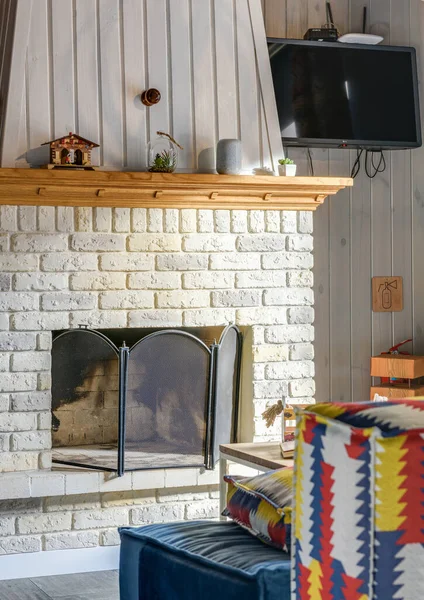 Stock image Stone fireplace in a country house with a multi-colored ethno sofa. High quality photo