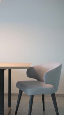 İskandinav tarzı bir iç mekanda gri bir sandalye masanın kenarında duruyor. Yüksek kaliteli FullHD görüntüler