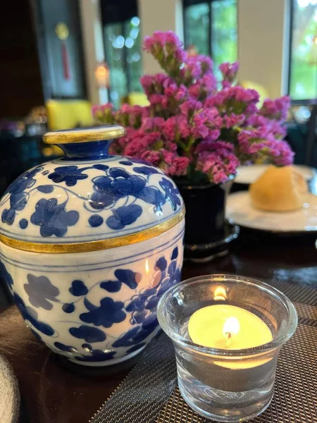 Ceramic vase and candle on a table in a restaurant