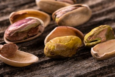 pistachios macro with selective focus on rough wooden background