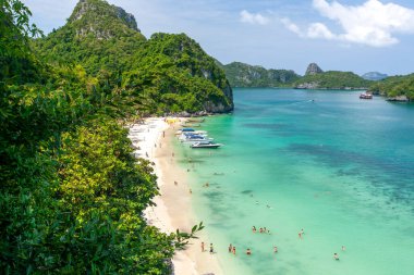 Güneşli bir yaz gününde Koh Ang Tanga Adası 'nın hava manzarası, dinlenen turistler, kumsalda güneşlenen ve mavi denizde şnorkelle yüzen. Mu Koh Ang Tanga Ulusal Parkı, Tayland.