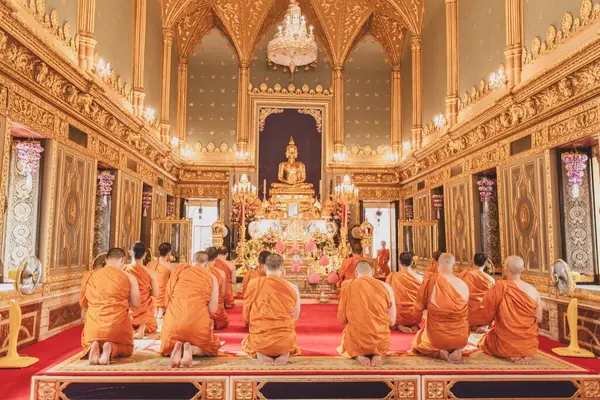 stock image Buddhist monks evening prayer chanting in the ancient temple at Wat Phra Kaew, a top tourist attraction in Asia. The Grand Palace, Bangkok, Thailand.