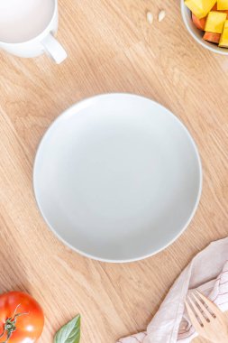 Kahvaltı için ahşap bir masada boş yeşil bir tabağın yakın çekimi. Dengeli beslenme kavramı. Üst Manzara. Düz yatıyordu.