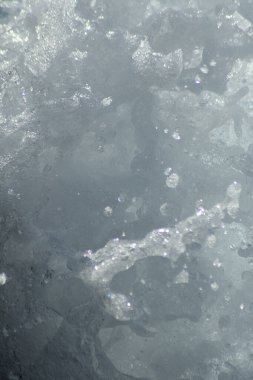 Beyaz köpüklü bir deniz dalgası kırılıyor.