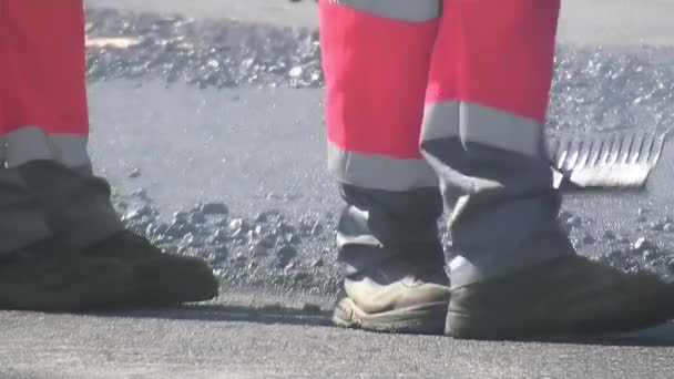 Trabalhador Dispersando Alcatrão Recém Derramado Uma Estrada Com Ancinho — Vídeo de Stock