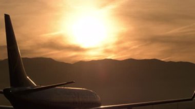 Uçak gün batımında havaalanına inecek.