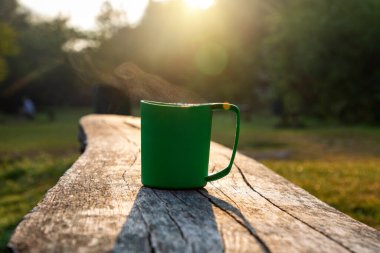 Tourist cup of coffee in the morning forest.