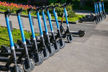 Electric scooters in the parking lot. Scooter rental for a trip around the city.