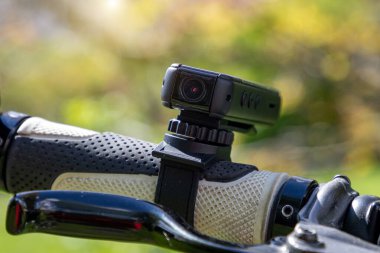 action camera on a bike. Mini video camera registrar clipart