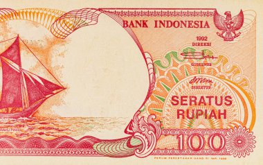 Endonezya 'dan gelen 100 rupiah banknotunun bir parçası, Pinisi Teknesi' ni resmediyor. Endonezya 'dan kağıt para.