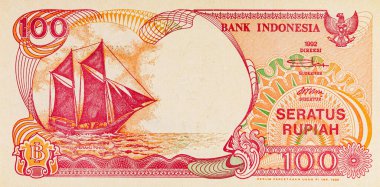 Endonezya 'dan gelen 100 rupiah banknotunun bir parçası, Pinisi Teknesi' ni resmediyor. Endonezya 'dan kağıt para.