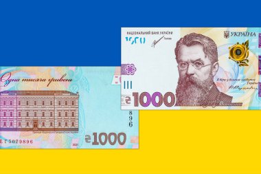 Ukrayna banknotu Ukrayna bayrağının arka planında 1000 Hryvnia. Ukrayna 'nın kağıt parası.