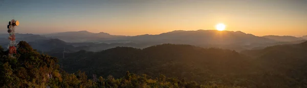 Military telecommunication station Panoramic sunrise over the mountains in northern Thailand, Ban Pang Pai, Mae Moh, Lampang. Beautiful sunlight.