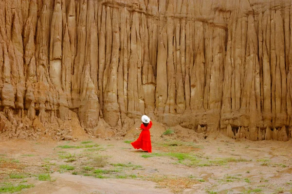 stock image Women and landscape of soil textures eroded sandstone pillars, columns and cliffs, natural erosion of water and wind, Sao Din Na Noi, Hom Chom, Khok Suea at sri nan national park in Nan Province.