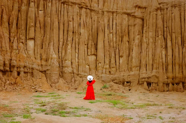 stock image Women and landscape of soil textures eroded sandstone pillars, columns and cliffs, natural erosion of water and wind, Sao Din Na Noi, Hom Chom, Khok Suea at sri nan national park in Nan Province.