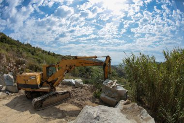 Processing of marble in the quarry. Crane for excavating marble in the quarry