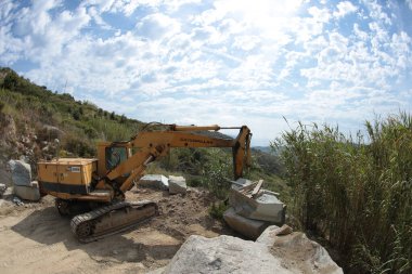 Processing of marble in the quarry. Crane for excavating marble in the quarry