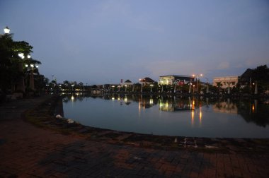 Semarang, Central Java, Indonesia - June 14, 2010: View of Semarang city at night with the reflections of the lights in the river. clipart