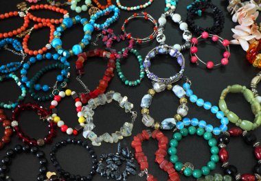 bracelets, beads on a black background ...