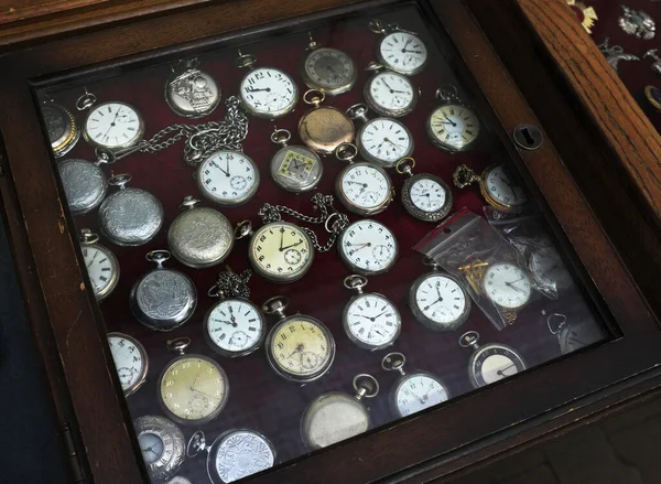 old pocket watches in a display case...