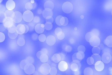 Abstract festive gradient blue white silver bokeh background texture with white bokeh lights. Beautiful backdrop with space for christmas, invitation, or other holidays.