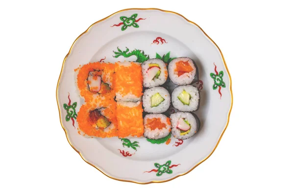 Traditional japanese sushi menu. Close-up of various kinds of sushi rolls with salmon, sashimi and other slices of raw fish served on a colorful plate. Clipping path. Macro. Top view.