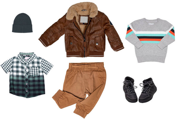 Collage set of little boys autumn clothes isolated. Denim trousers or pants, boots, sneaker, leather jacket, shirts and a cap for child boy. Children's spring fashion.