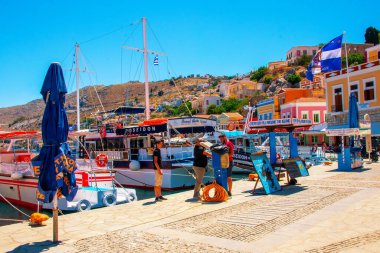 SYMI, Yunanistan - Haziran 03, 2021. Chorio ve Gialos ilçeleri ile Symi kasabası tüm Ege 'nin en güzel ve romantik limanlarından biridir. Dik yamaçlara uzanan renkli malikaneler.