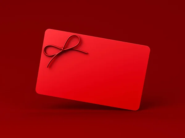 All red gift card or blank minimal red gift card or gift voucher with red rope ribbon bow isolated on dark red background minimal conceptual 3D rendering