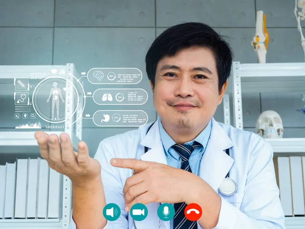 Asian man doctor explaining about functioning of the internal organs with virtual information graphics on webcam screen, online video conference with patient. Telemedicine with Asian male doctor.