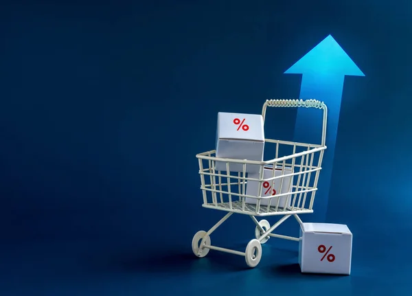 Inflation, increase sales, rising up price, business marketing concepts.  Red percentage icon on parcel boxes in white shopping cart trolley with rising arrows on blue background with copy space.