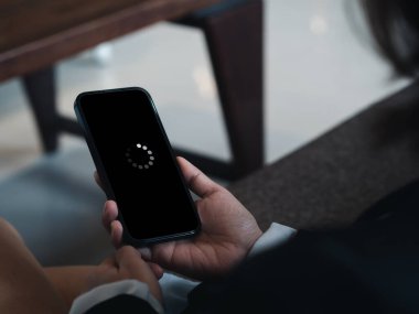 System error, slow loading, no connection to wifi on mobile smartphone screen in businessperson's hand. No signal internet connection on cellphone. System software update and upgrade loading process.