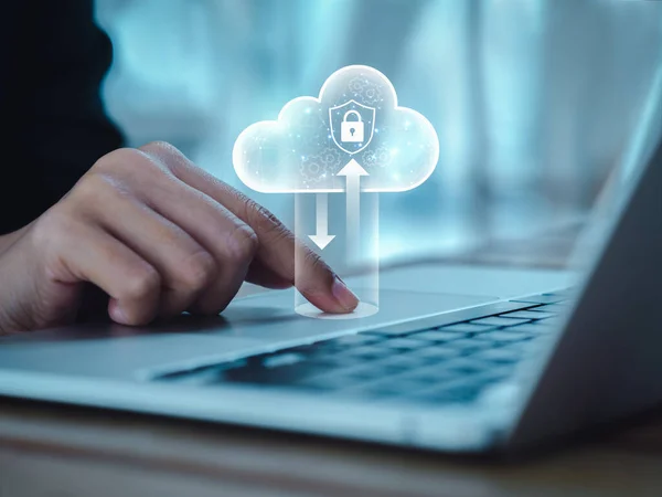 Cloud computing technology management concept. Cloud with digital lock icons appearing while business people working with laptop computer, transfer data by finger on touchpad. Protection and security.